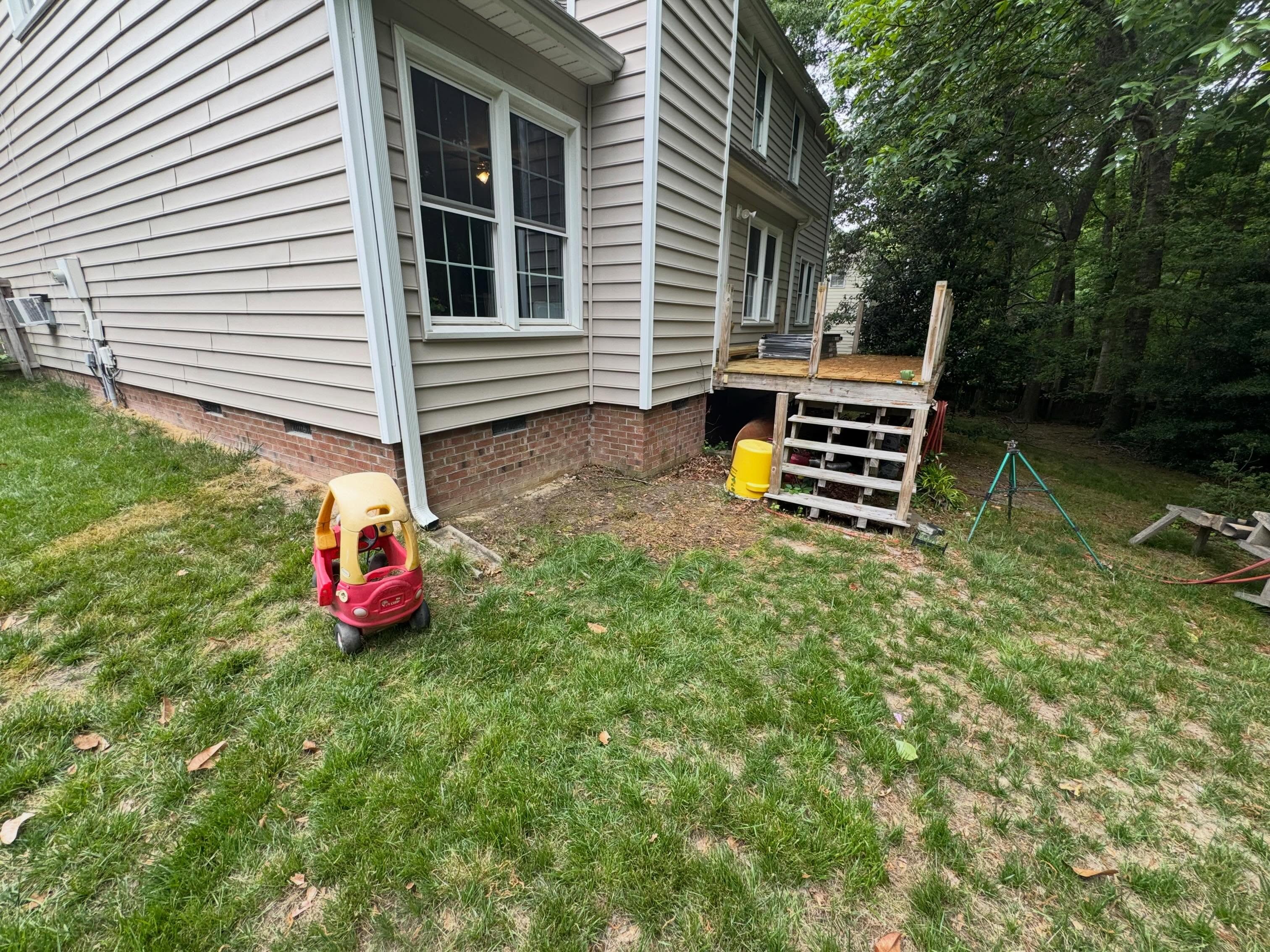 An EMC junk removal project after discarded materials were cleared from beside the home