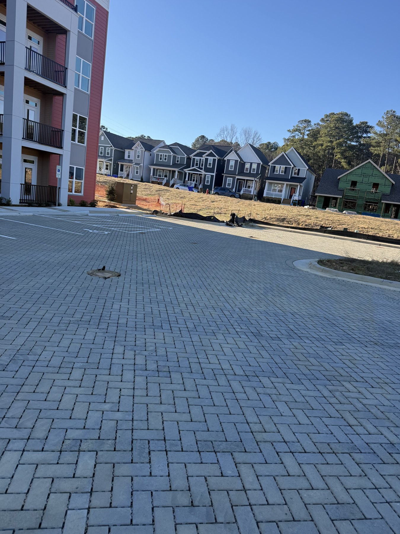 Broad interlocking paver entrance beside residential buildings