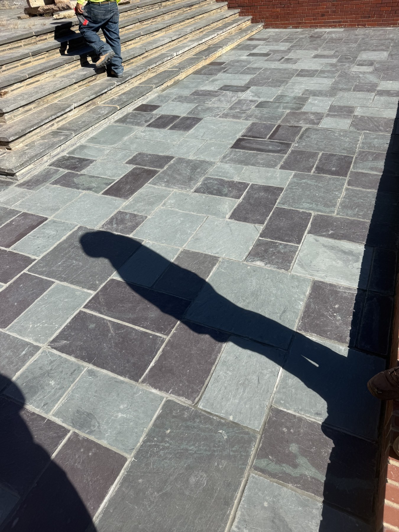 Mixed gray pavers beside exterior steps