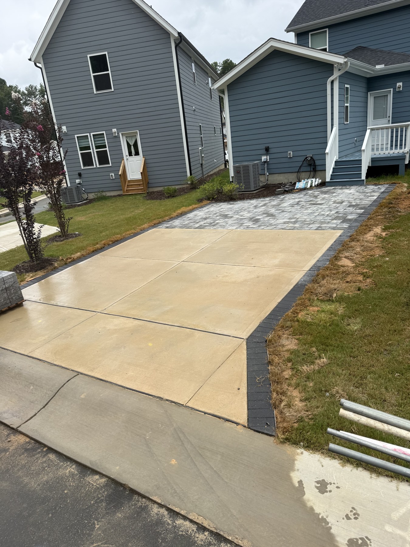 Concrete driveway leading toward a residential garage